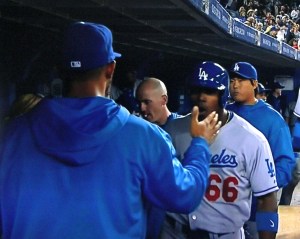 Matt Kemp congratulates Yasiel Puig in the dugout after he scored from first to tie the game in the 9th inning.