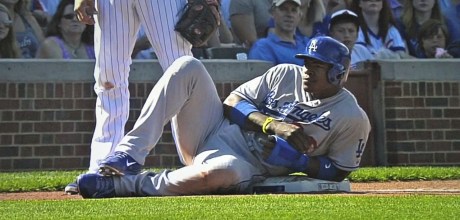 Dodger outfielder Yasiel Puig takes a breather at third base during a game in Chicago.