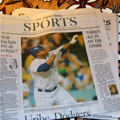 Nice photo in The Times by Wally Skalij shows Juan Uribe hitting one of three homers against Arizona.